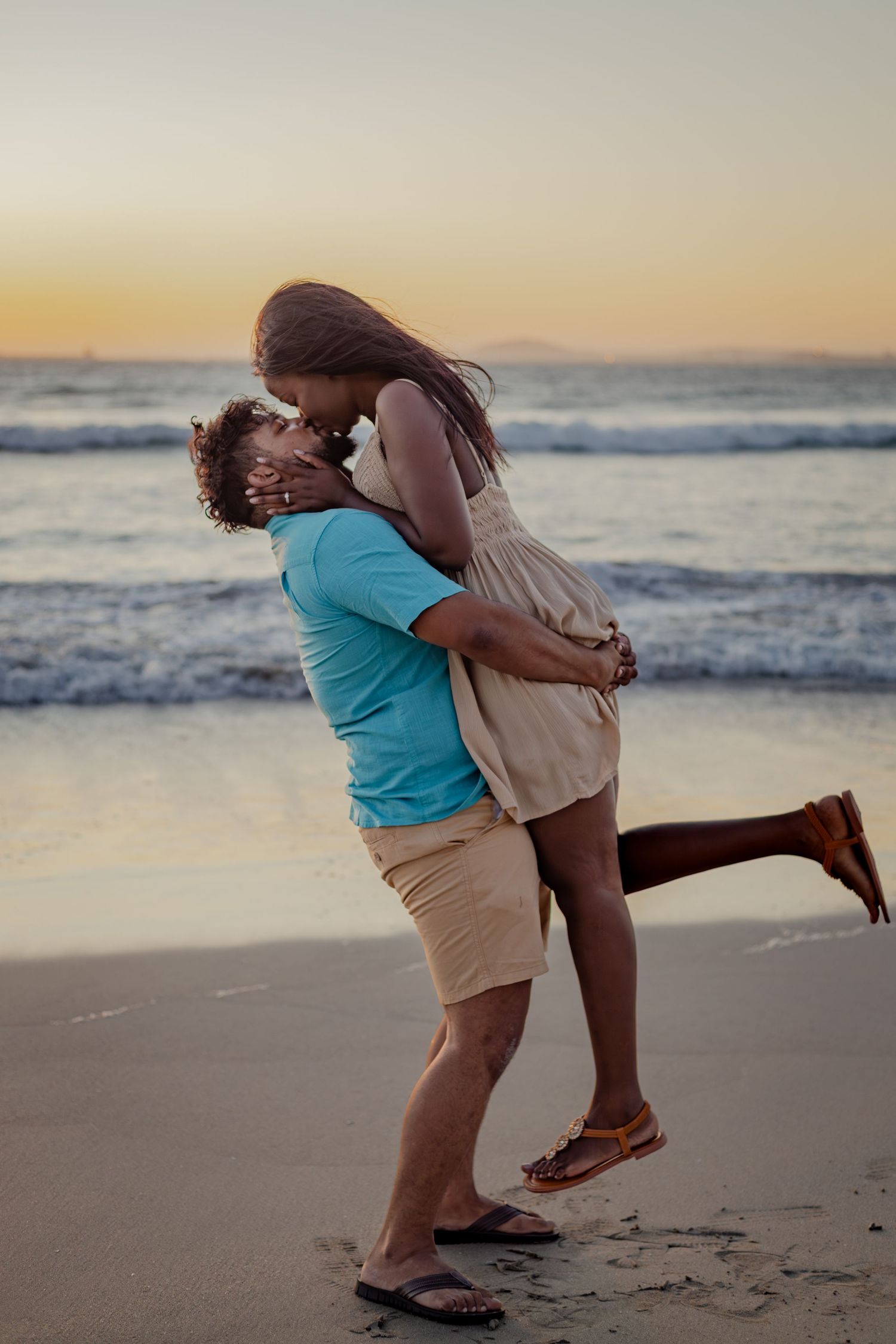 Couple embracing on the beach at sunset