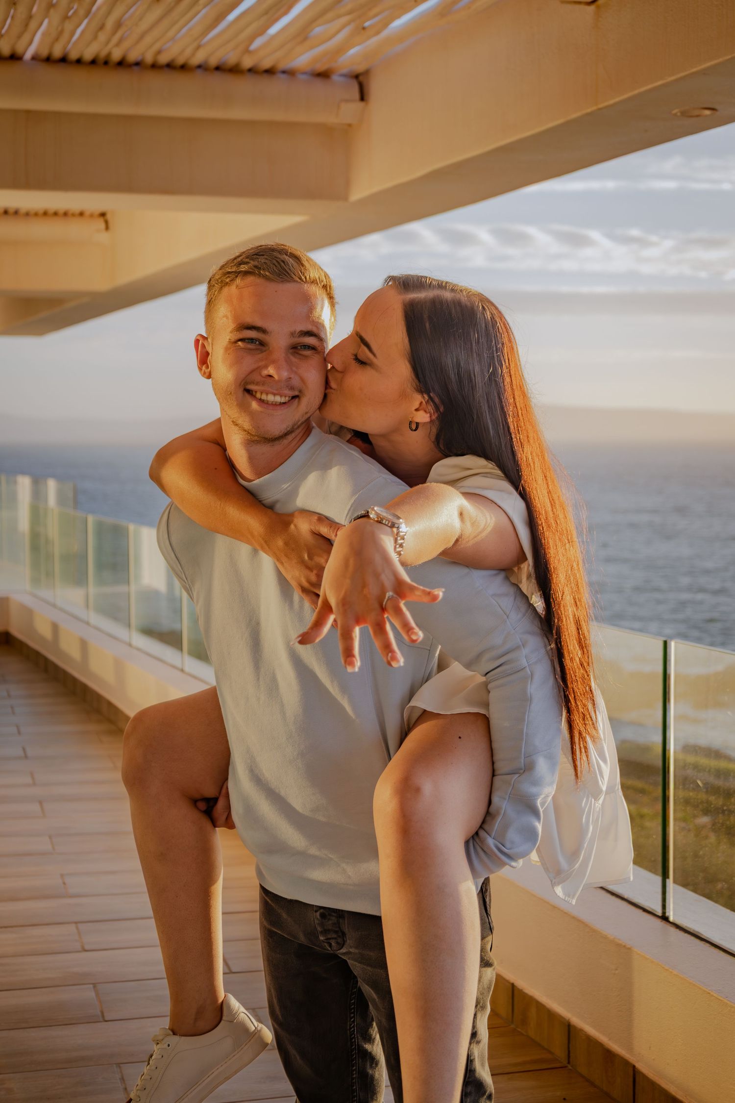 Couple walking along a balcony overlooking the coast