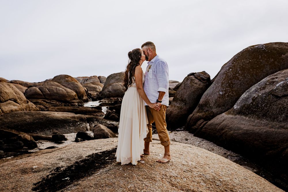 Couple on shoreline rocks