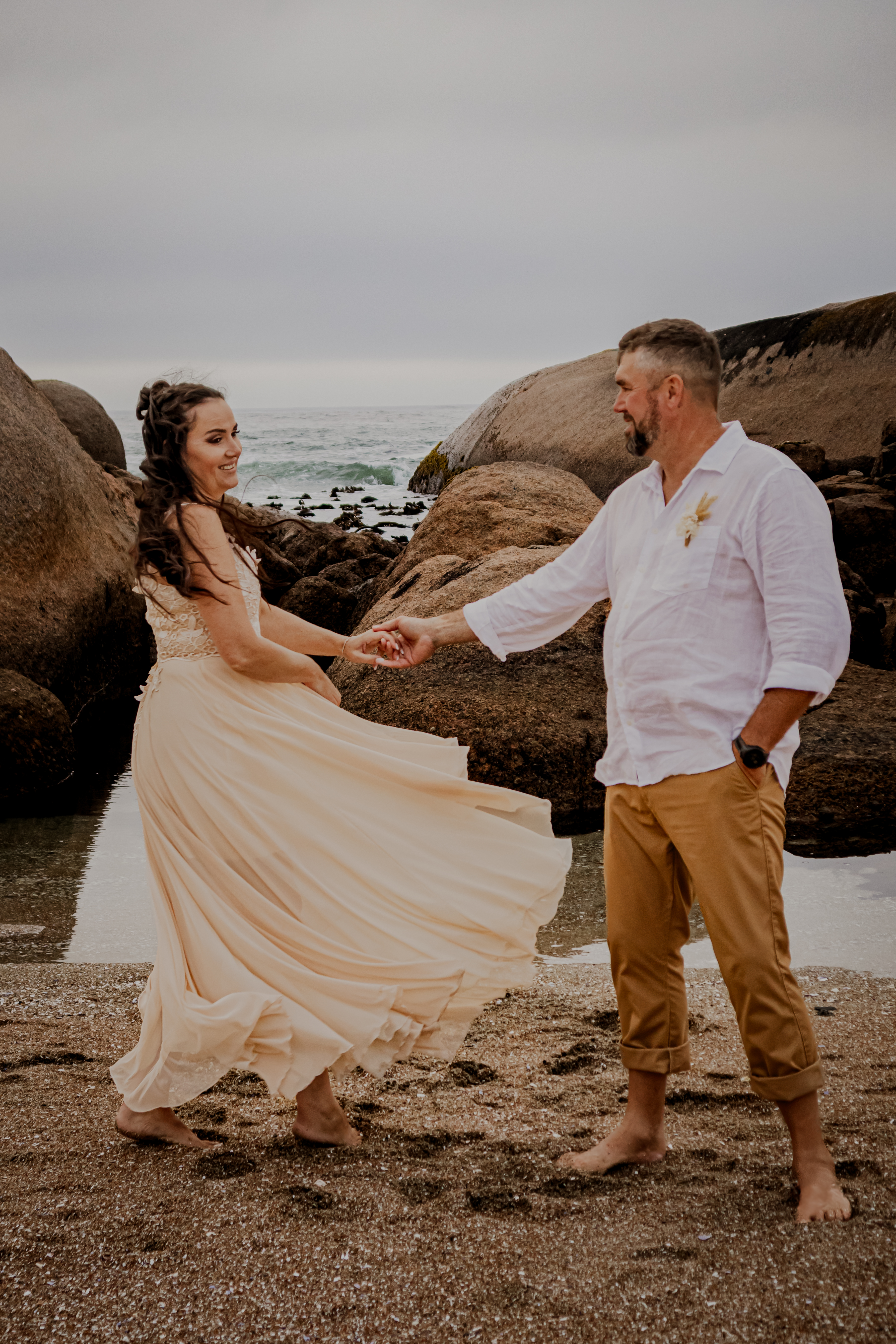 Couple holding hands on the beach