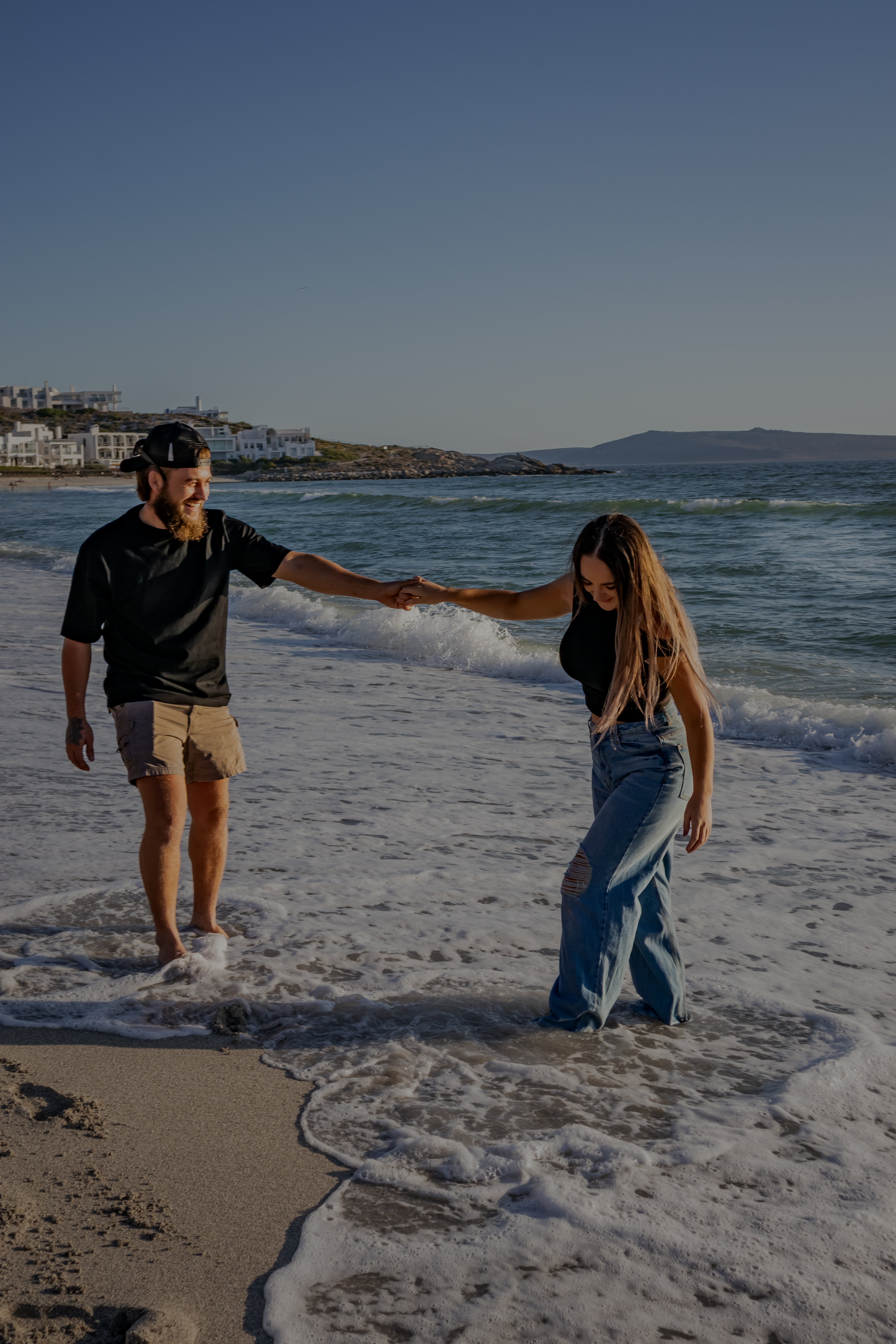 Couple holding hands on the beach