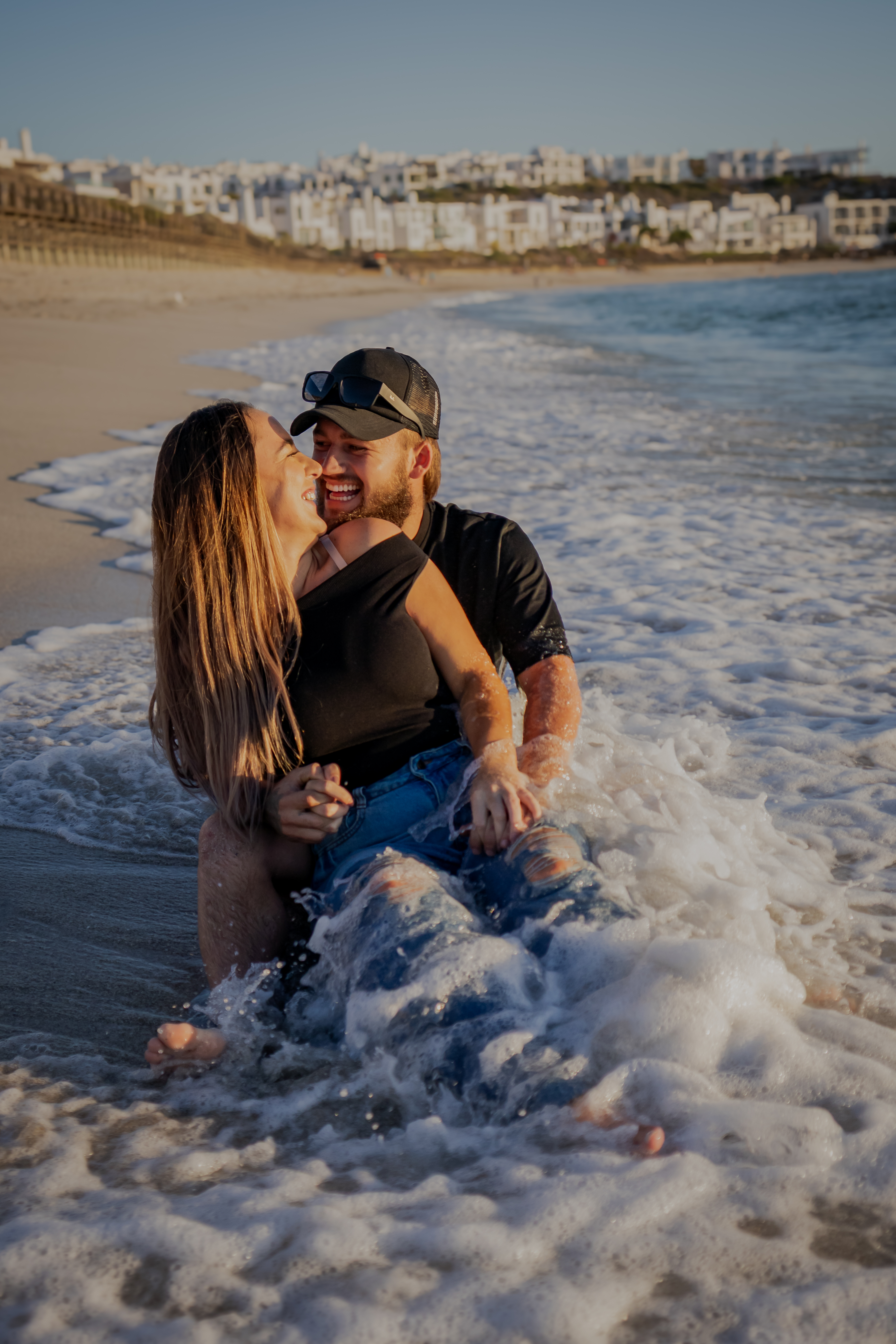 Couple embracing in the surf