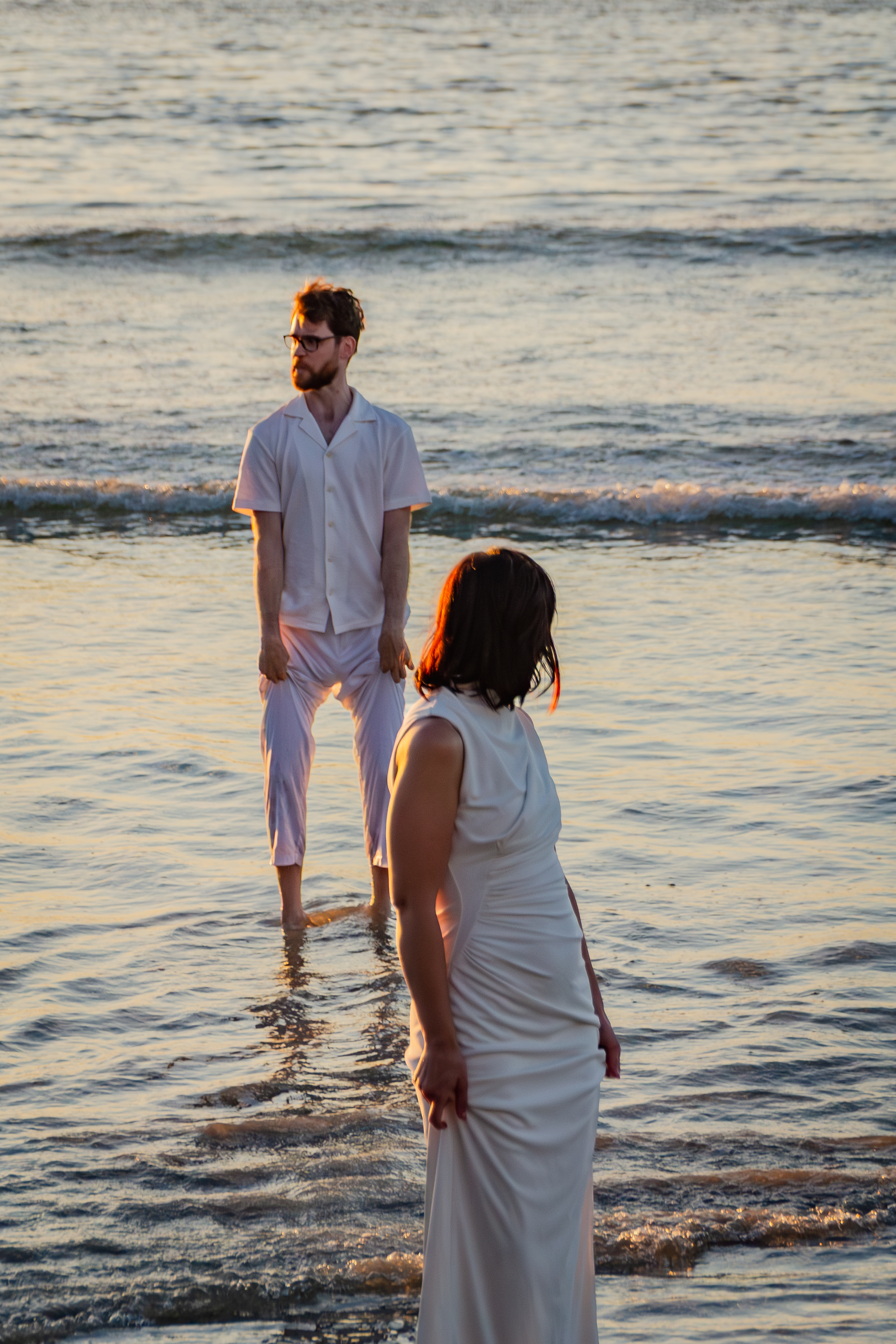 Bride smiling on the shoreline