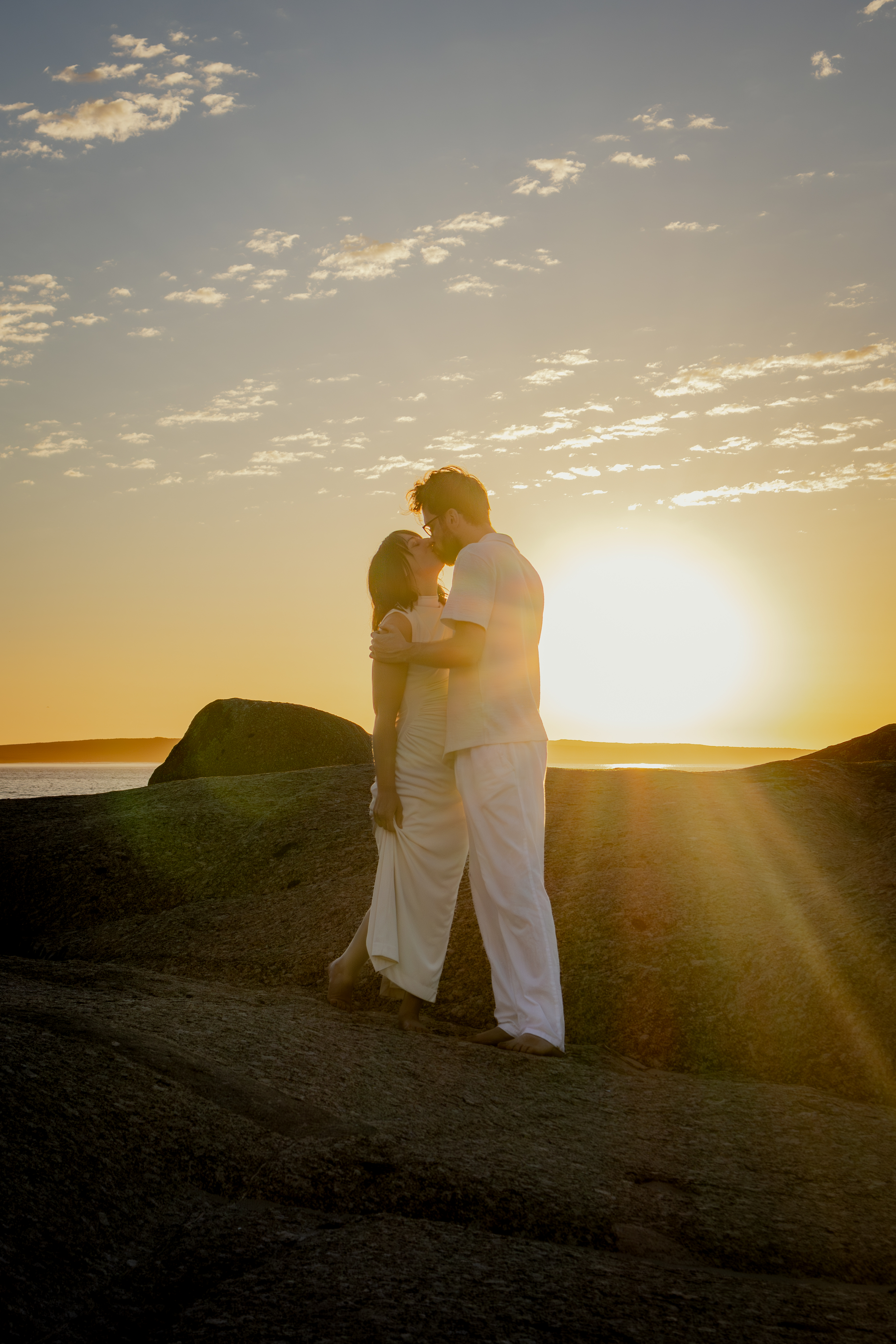 Couple embracing in golden sunset light