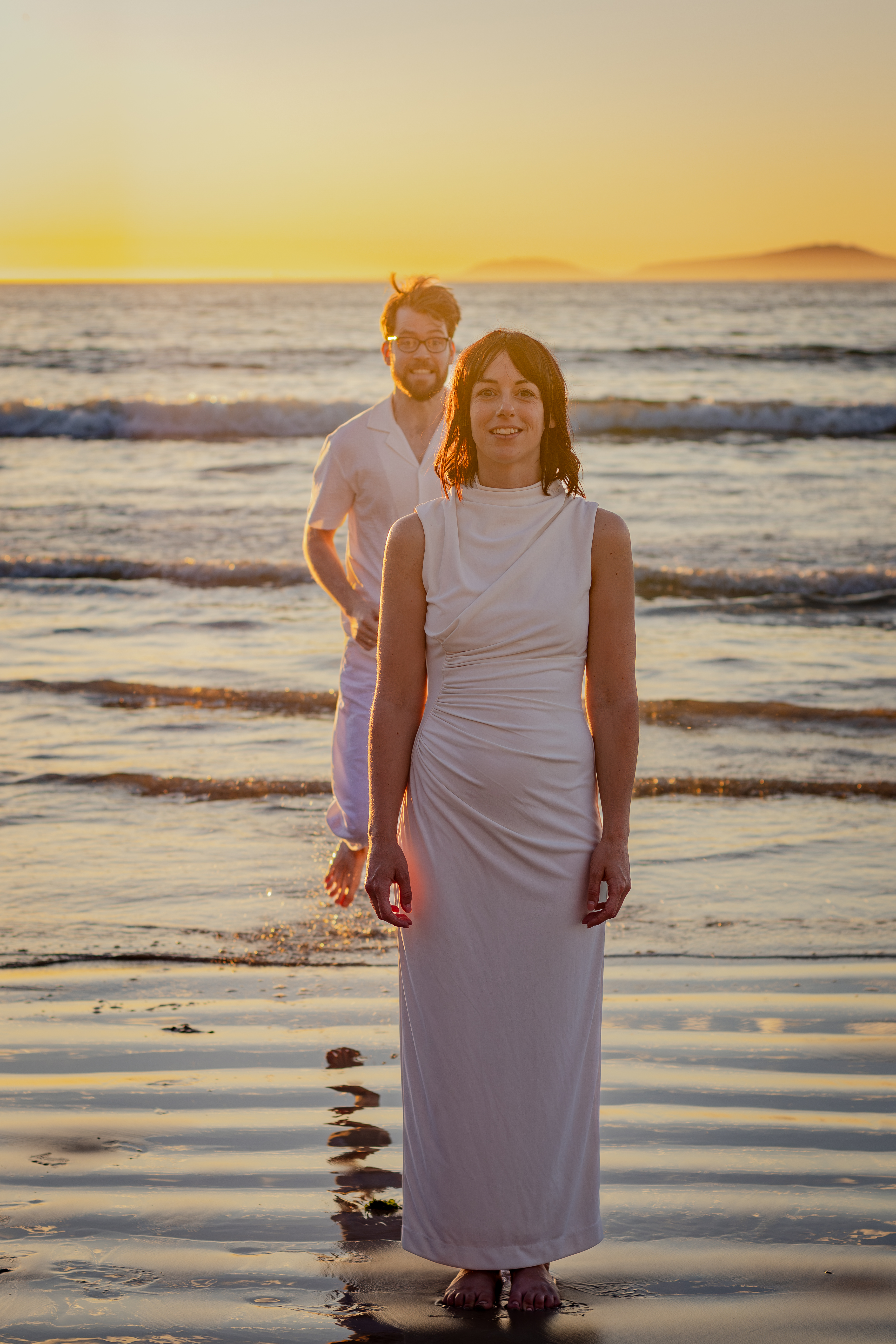 Bride posing softly in the surf