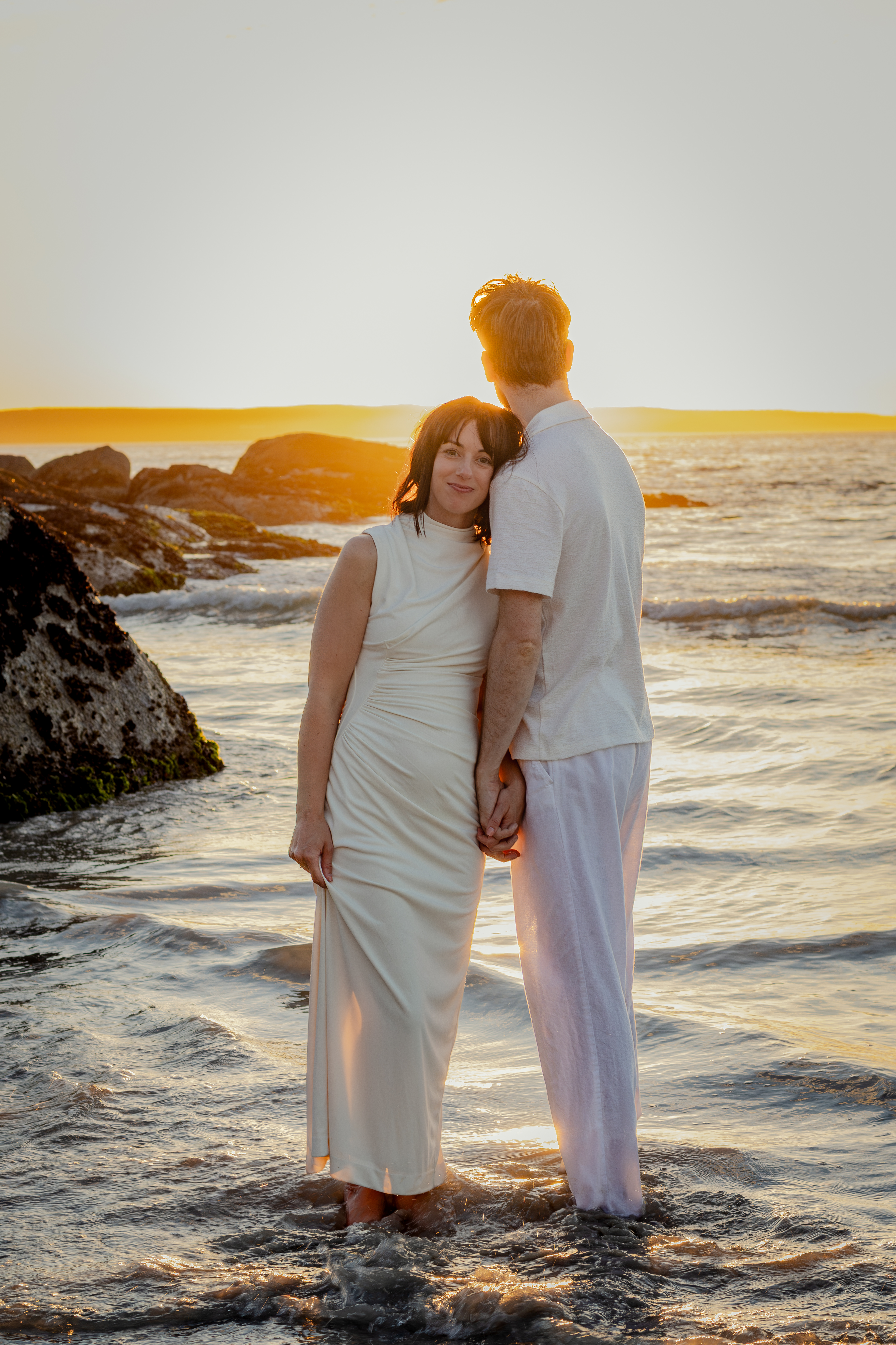 Couple facing each other in soft sunset light