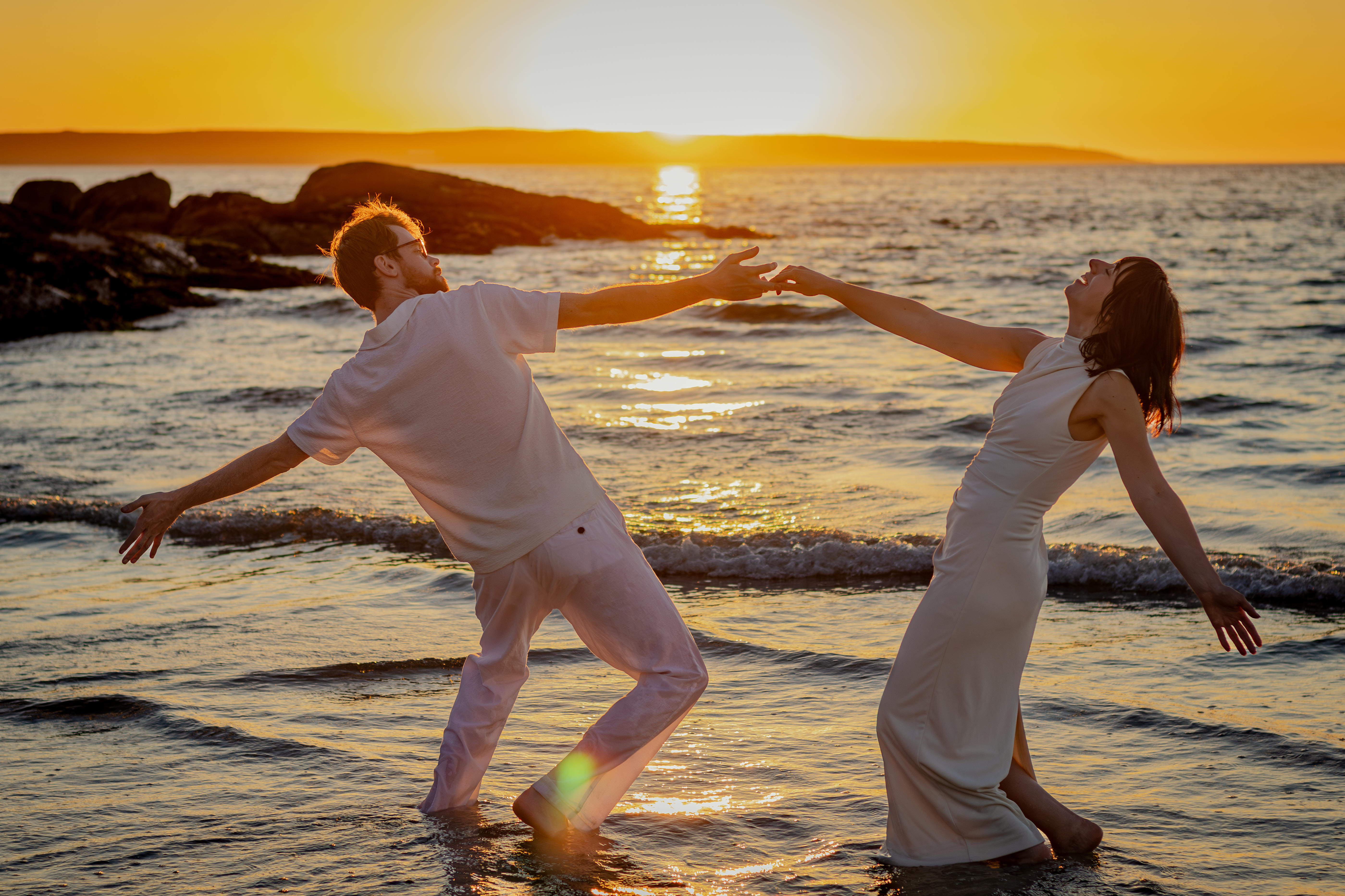 Couple running hand in hand along the shore
