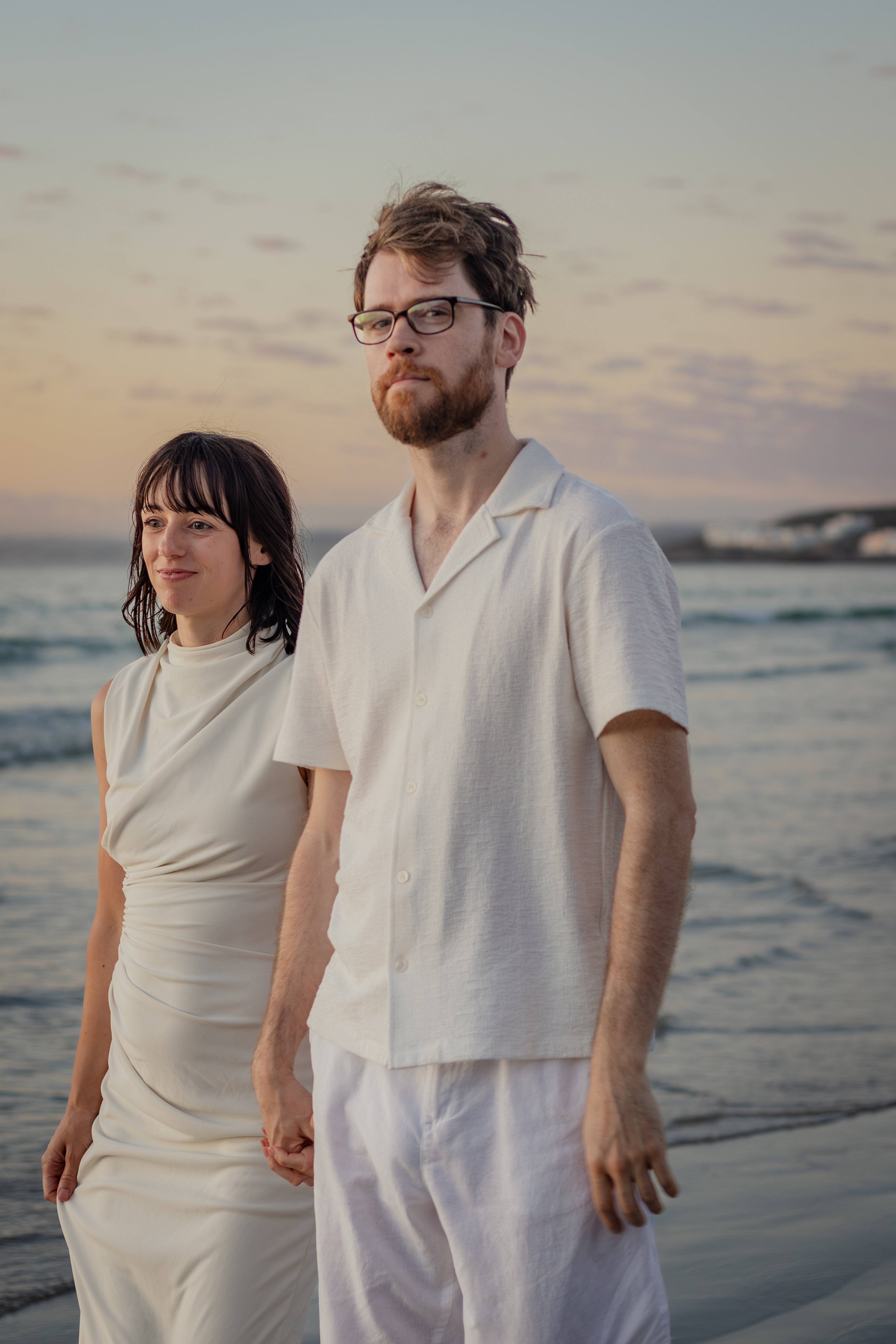 Couple standing together on the shoreline
