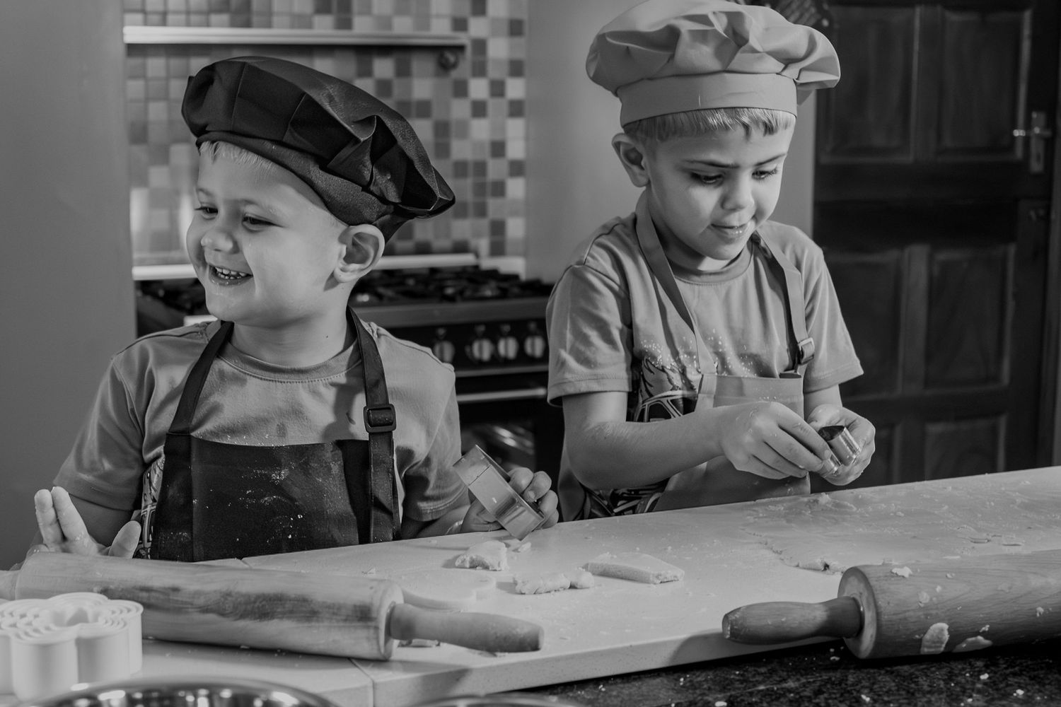 Black and white portrait of children baking together