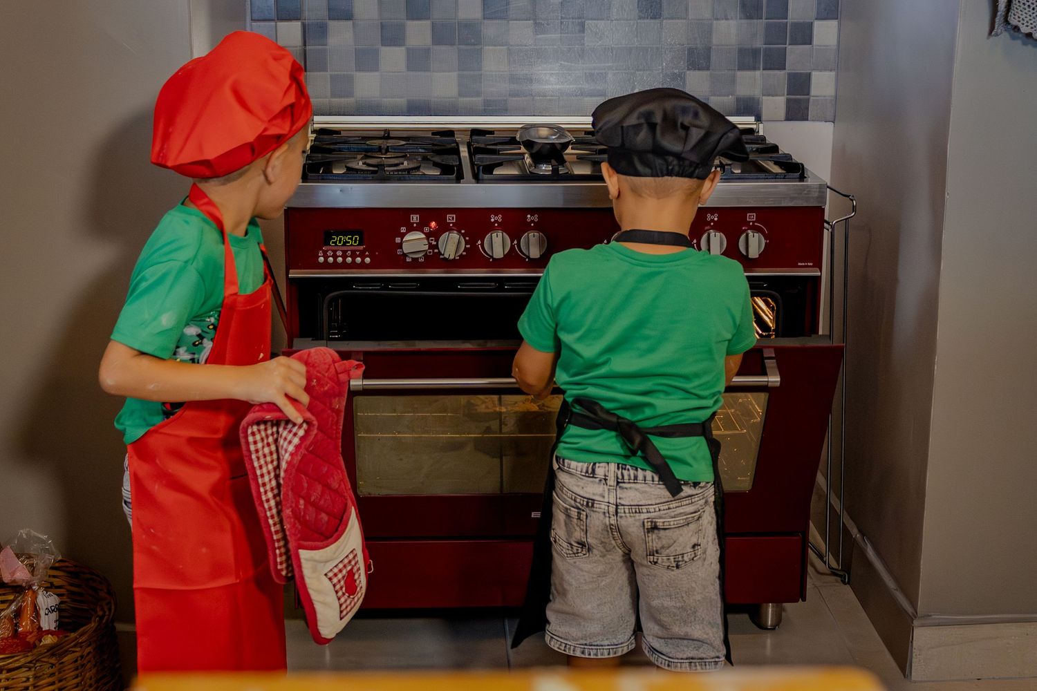 Children standing at the oven together