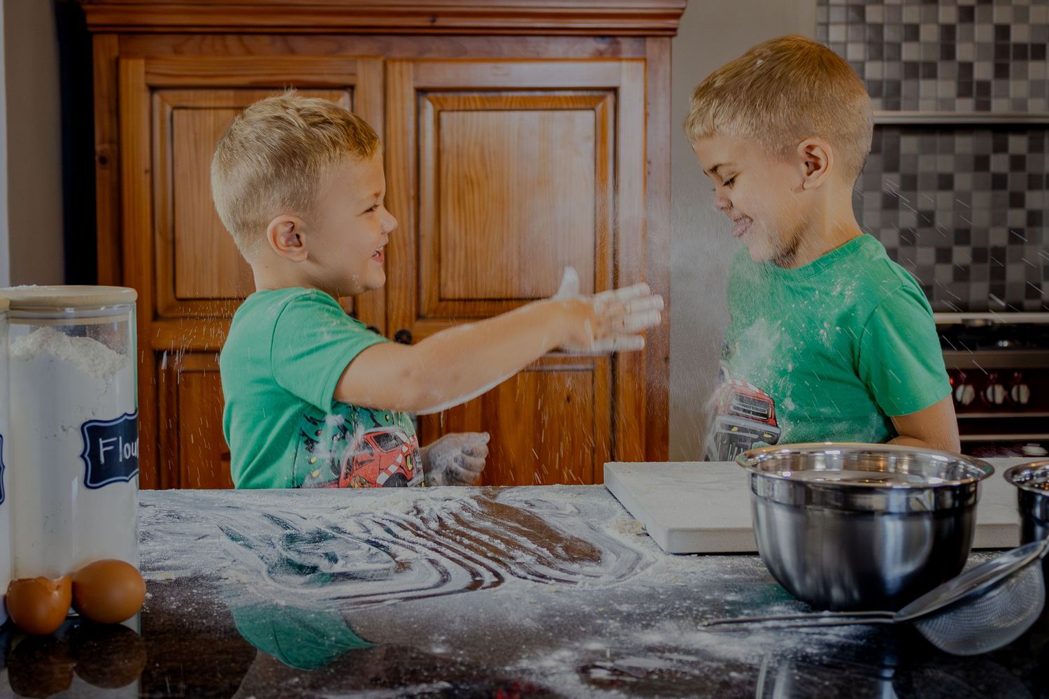 Children sharing a baking moment at the counter
